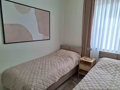 a bedroom with two beds and a picture on the wall at Apartment Belgrade Waterfront LUX -Libera 413 in Belgrade