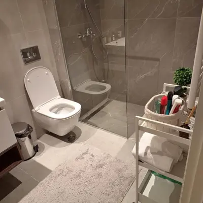 a bathroom with a toilet and a glass shower at Apartment Belgrade Waterfront LUX -Libera 413 in Belgrade
