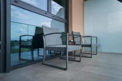 a row of chairs sitting on a balcony at Libera Luxe Residence in Belgrade