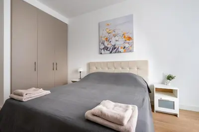a bedroom with a large bed with two towels on it at Terra river view in Sajmište