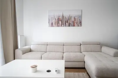 a living room with a couch and a coffee table at Terra river view in Sajmište
