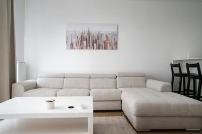 a living room with a couch and a table at Terra river view in Sajmište
