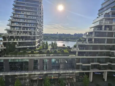 a view of a river between two tall buildings at Terra river view in Sajmište