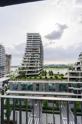 a view of a tall building from a balcony at Terra river view in Sajmište