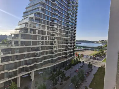 a tall building with a street in front of it at Terra river view in Sajmište