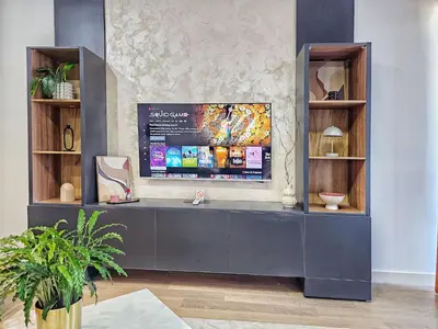 a desk in a living room with a wall at ARTA LUX - Galerija Beograd na vodi - Belgrade Waterfront in Belgrade