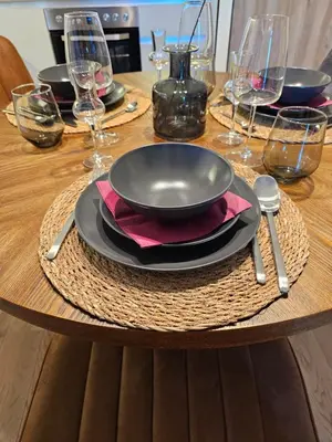 a wooden table with a plate and a bowl on it at ARTA LUX - Galerija Beograd na vodi - Belgrade Waterfront in Belgrade