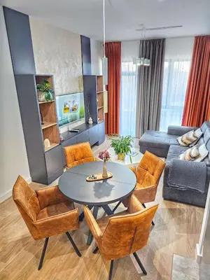 a living room with a table and chairs and a couch at ARTA LUX - Galerija Beograd na vodi - Belgrade Waterfront in Belgrade