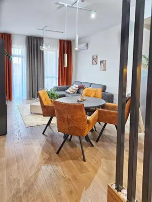 a living room with a table and a couch at ARTA LUX - Galerija Beograd na vodi - Belgrade Waterfront in Belgrade