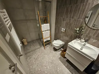 a bathroom with a sink and a toilet and a mirror at ARTA LUX - Galerija Beograd na vodi - Belgrade Waterfront in Belgrade