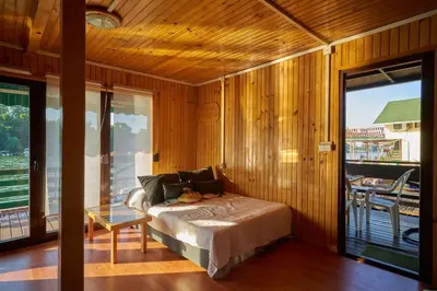 a bedroom with a bed in a room with a balcony at Homey house boat, great location in Ada Ciganlija