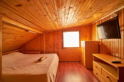 a bedroom with a bed and a television in a room at Homey house boat, great location in Ada Ciganlija