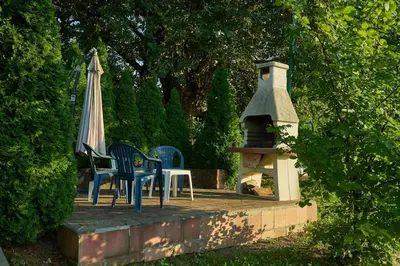 a table and chairs sitting on a patio with a gazebo at Homey house boat, great location in Ada Ciganlija