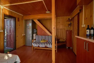 a living room with a couch and a refrigerator at Homey house boat, great location in Ada Ciganlija