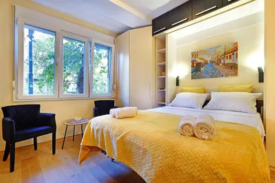 a bedroom with a large bed with two towels on it at Skadarlija discovery Beograd centar lux in Belgrade