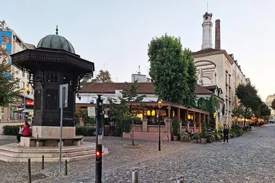 a city street with a building and a clock tower at Skadarlija discovery Beograd centar lux in Belgrade
