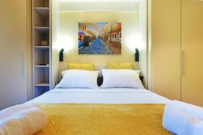 a bedroom with a bed with a painting on the wall at Skadarlija discovery Beograd centar lux in Belgrade
