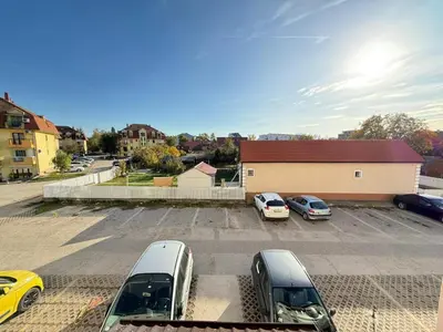 a parking lot with several cars parked in it at Infinity Apartman Obrenovac, sa parkingom privatnim in Obrenovac