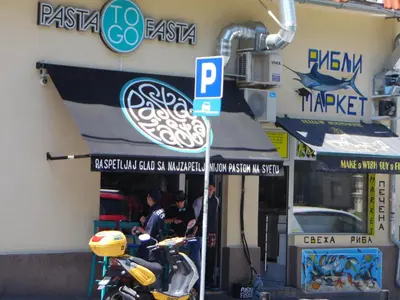 a motorcycle parked in front of a restaurant at Apartment Vracar in Belgrade