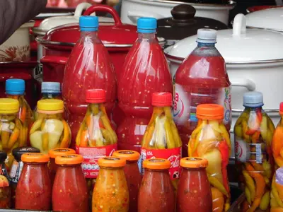 a bunch of different types of bottles of sauce at Apartment Vracar in Belgrade