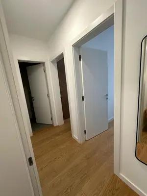 an empty room with two doors and a mirror at K District apartment Belgrade - central BG, private parking in Belgrade