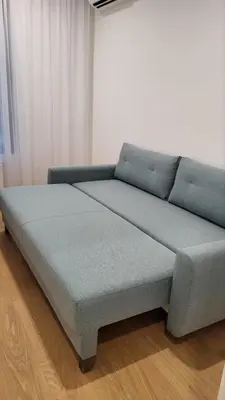a blue bed sitting on a wooden floor in a room at K District apartment Belgrade - central BG, private parking in Belgrade