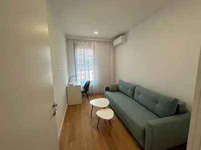 a living room with a green couch and a table at K District apartment Belgrade - central BG, private parking in Belgrade