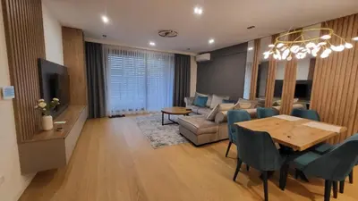 a living room with a table and a dining room at K District apartment Belgrade - central BG, private parking in Belgrade