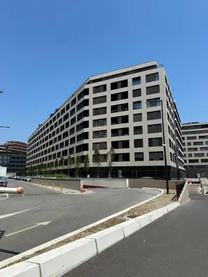 an empty parking lot in front of a large building at K District apartment Belgrade - central BG, private parking in Belgrade
