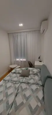 a bedroom with a large bed and a couch at K District apartment Belgrade - central BG, private parking in Belgrade