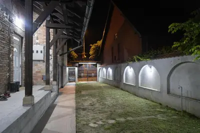 an alley at night with a brick wall at Smestaj Centar Ub 35 in Ub
