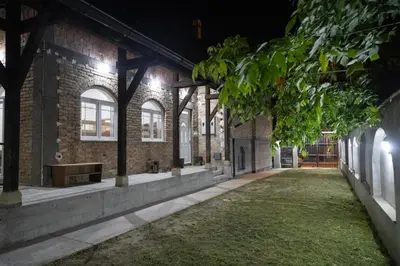 an empty courtyard of a brick building at night at Smestaj Centar Ub 35 in Ub