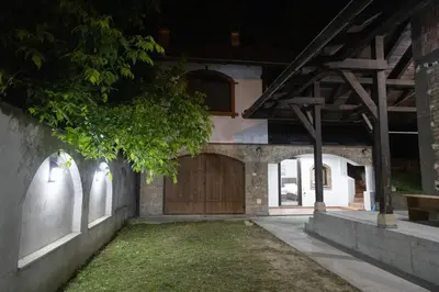 a house with a wooden garage door at night at Smestaj Centar Ub 35 in Ub