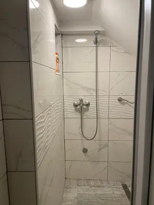 a shower with a glass door in a bathroom at Travel Home in Belgrade