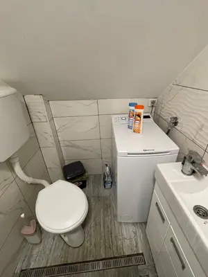 a small bathroom with a toilet and a sink at Travel Home in Belgrade