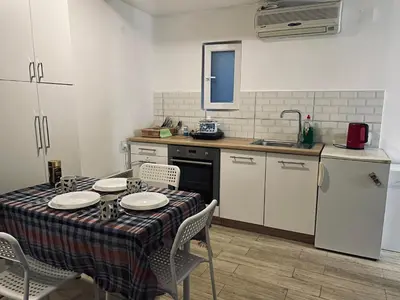 a kitchen with a table and a kitchen with a table and chairs at Travel Home in Belgrade