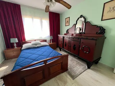 a bedroom with a bed and a dresser with a blue blanket at La Corte Delle Rose UB in Ub