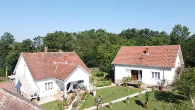an aerial view of two white houses with a yard at La Corte Delle Rose UB in Ub