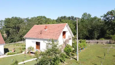 a small white house with a red roof at La Corte Delle Rose UB in Ub