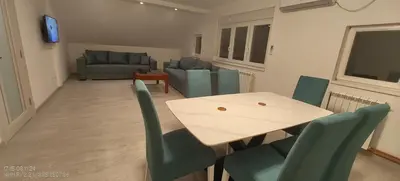 a living room with a table and chairs and a couch at Miki Private Room in Belgrade