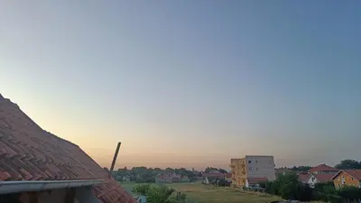 a view of a city with a sunset in the background at Miki Private Room in Belgrade