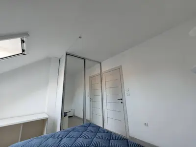 a bedroom with a bed and a mirror at Miki Private Room in Belgrade