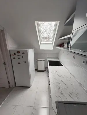 a kitchen with a white refrigerator and a window at Miki Private Room in Belgrade