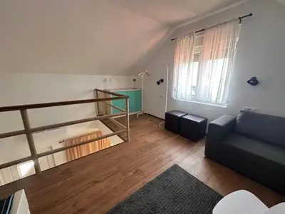 a living room with a staircase and a couch at Villa Popovic - apartments Fruska gora in Sremski Karlovci