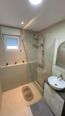 a bathroom with a glass shower and a sink at Villa Popovic - apartments Fruska gora in Sremski Karlovci