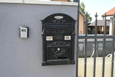 a black post box on the side of a building at Villa Popovic - apartments Fruska gora in Sremski Karlovci