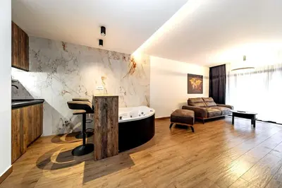 a large living room with a tub and a couch at Dark Nest 2 Belgrade Apartments in Belgrade