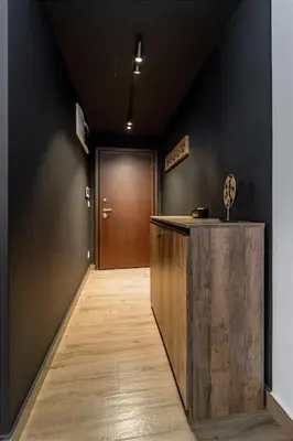 a hallway with a wooden counter and a door at Dark Nest 2 Belgrade Apartments in Belgrade