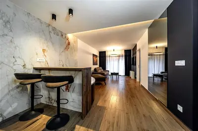 a living room with a counter and stools in a room at Dark Nest 2 Belgrade Apartments in Belgrade