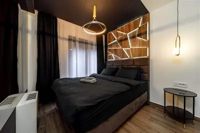 a bedroom with a black bed and a window at Dark Nest 2 Belgrade Apartments in Belgrade